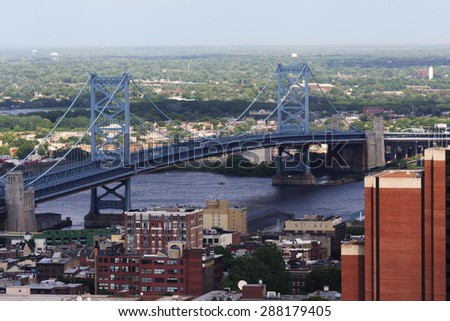 The Benjamin Franklin Bridge crosses the Delaware River connecting Philadelphia, Pennsylvania and Camden New Jersey.  The suspension bridge has been in service since 1926