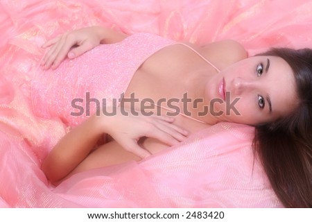 beautiful girl laying on peach prom dress