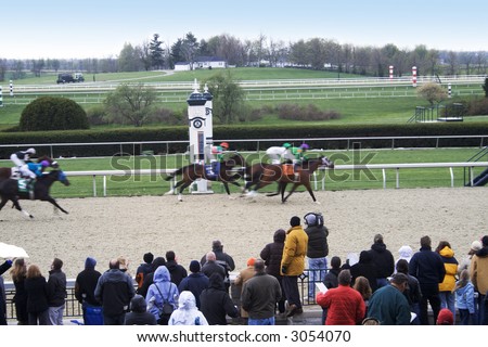 Horses crossing the finish line in a close race at Keenland RAce track in Lexington, Kentucky