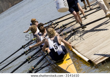 Scull crew getting ready to launch their boat from the dock