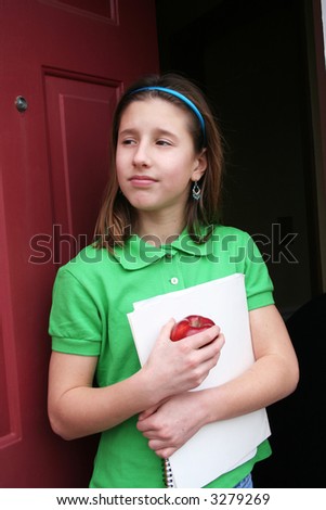 Young girl getting ready to leave for the first day of school
