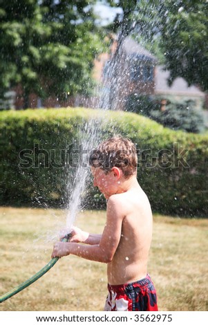 Spraying the hose to cool off in the hot weather