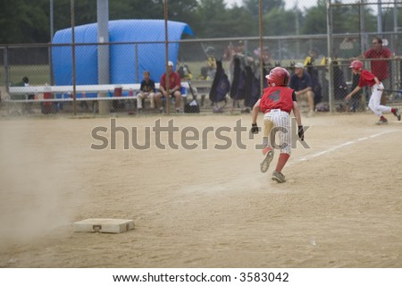 youth baseball player running for home on the hit