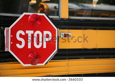 stop sign on the side os a school bus