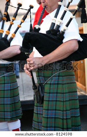 Irish man in his kilt playing his bagpipe