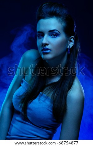 Portrait of the beautiful girl in dark tones