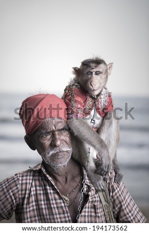 Portrait of an Indian old man with monkey