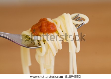 freshly made spaghetti with red sauce, rolled on fork