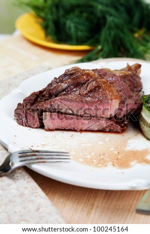 Piece of fried rib eye steak medium rare