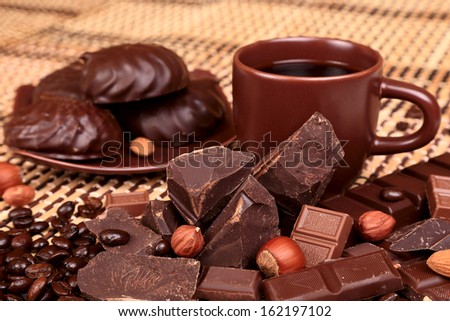 Crushed chocolate on a background coffee cup and bamboo napkin, selective focus