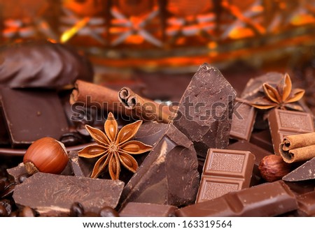 Mixture of pieces of chocolate spices and nuts close-up, selective focus