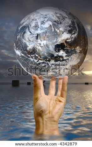 hand holding a globe with reflection in the water