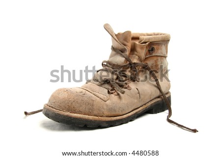 Dirty old brown pigskin leather work boot, very worn, with metal reinforcements to the sole