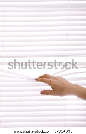 hands apart on the window blinds..