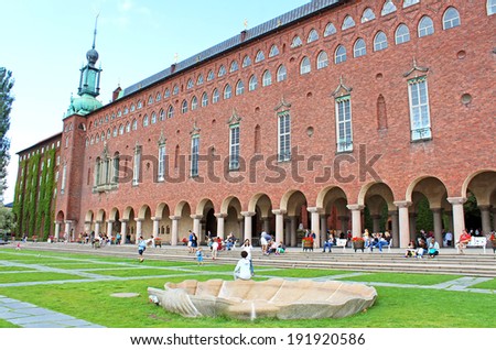 STOCKHOLM, SWEDEN - AUGUST 12, 2013: Unknown people are resting near City Hall in Stockholm, Sweden