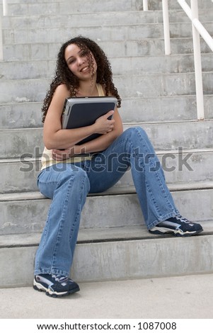 Young Latina Student Hugging Computer