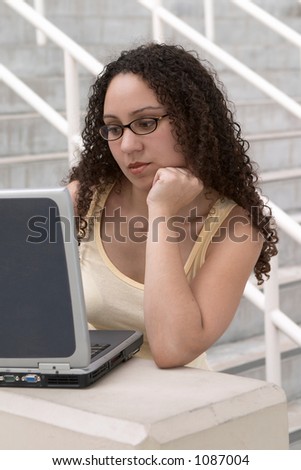 Young Latina Student with Computer and Glasses
