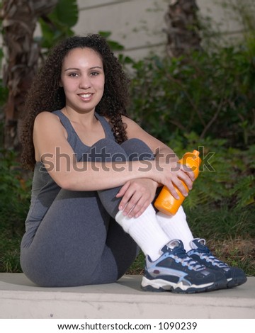 Young Latina with Orange Sports Water Bottle