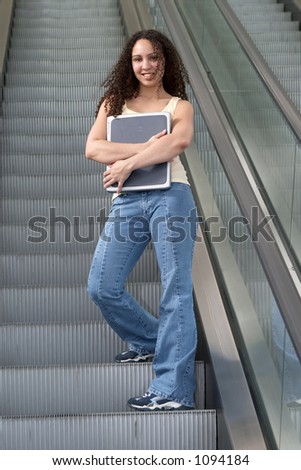 Young Latina Student Hugging on Escalator
