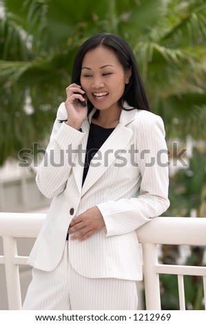 Asian Business Woman with Cell Phone Laughing