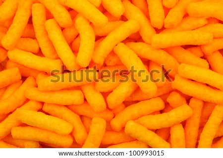 Closeup of cheese puffs. Fills the frame.