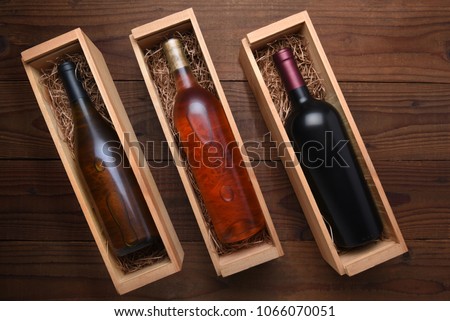 Three Wine Boxes: Blush, Cabernet and Chardonnay wine bottles in individual cases with packing straw.