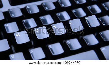 The word Money spelled out on a computer keyboard. Only the keys forming Money are in focus.