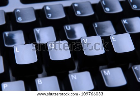 The word Love spelled out on a computer keyboard. Only the keys forming Love are in focus.