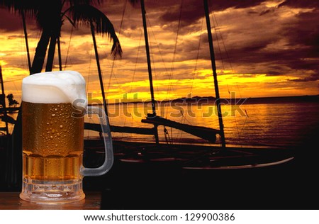 Beer mug and a tropical sunset