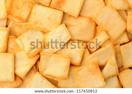 Closeup of a pile of pita chips. Horizontal format filling the frame.