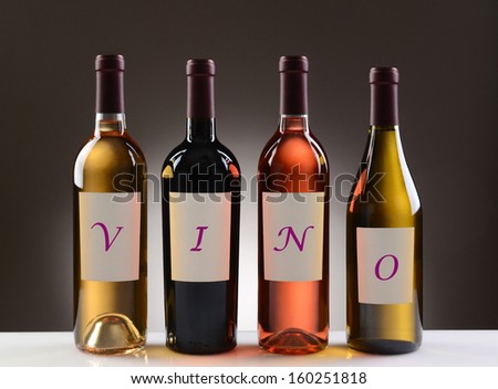Four Wine Bottles with their labels spelling out the word VINO, on a light to dark gray background. Wines include: Cabernet Sauvignon, Chardonnay, Sauvignon Blanc, and White Zinfandel.