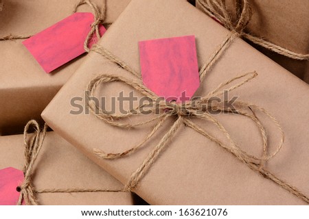 Closeup of a group of Christmas presents wrapped with brown eco friendly craft paper. Horizontal format.