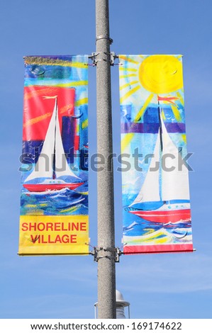 Long Beach, Ca - September 21, 2012: Shoreline Village Banners On A Light Pole, Long Beach, California. Shoreline Village Is A Popular Tourist Destination With Shops, Restaurants On The Waterfront.