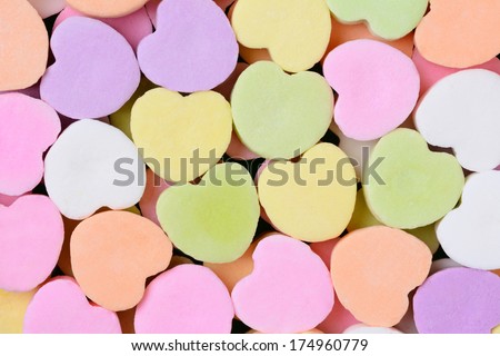 Macro shot of pastel candy hearts for Valentine\'s Day. The hearts are all bland and ready for your message.