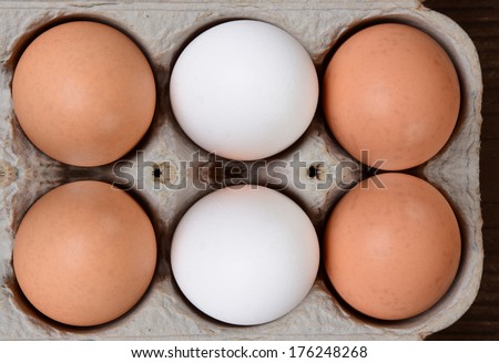 High angle view of a carton of brown and white farm fresh eggs.
