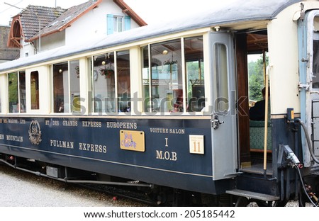 BROC, SWITZERLAND - JULY 8, 2014: The Chocolate Train at station. The luxury tourist train departs from Montreux to stops in Gruyere and Broc for cheese and chocolate factory tours.
