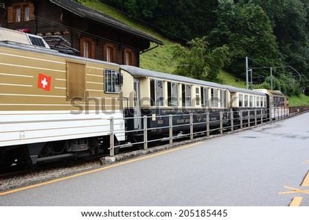 BROC, SWITZERLAND - JULY 8, 2014: The Chocolate Train at station. The vintage luxury tourist train departs from Montreux to stops in Gruyere and Broc for cheese and chocolate factory tours.