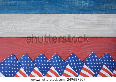 High angle shot of American Flag napkins spread out on a red, white and blue picnic table. Horizontal format with copy space. Suitable for American Holidays: 4th of July and Memorial Day,