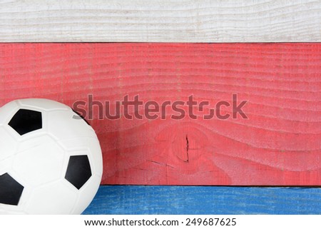 High angle shot of a soccer ball on a red, white and blue picnic table. Horizontal format with copy space. Suitable for American Holidays: 4th of July and Memorial Day,