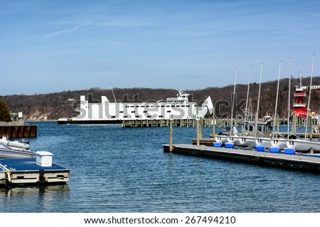 PORT JEFFERSON, NY - April 6, 2015: Auto Ferry leaving port. The ferry \'Park City\' leaves Port Jefferson, New York for Bridgeport Connecticut. The boat can carry 95 vehicles and 1,000 passengers.