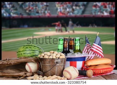 A big screen TV with a baseball game. In front of the television is a spread of snack food, beer and sports equipment. Great for Playoff or World Series themed projects. TV is out of focus.