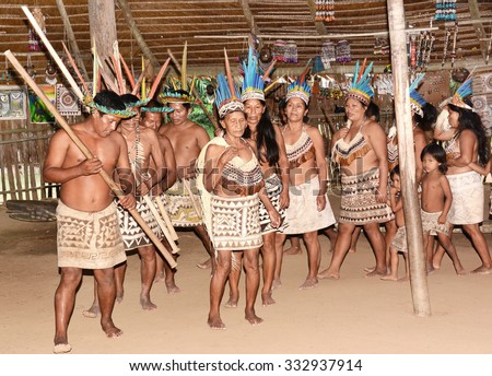 IQUITOS, PERU - OCTOBER 18, 2015: Bora community of Peru performing traditional dance. The tribe relocated from Ecuador dance in a traditional community hut.