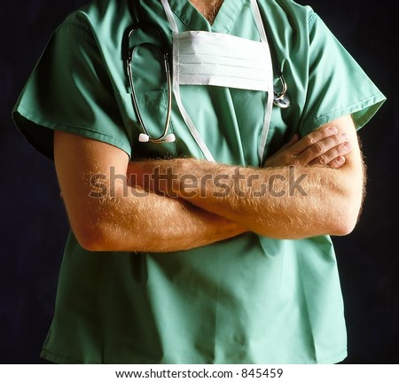 Doctor with Mask & Stethoscope draped around his neck standing with his arms folded. Torso shot only man is unrecognizable. Square Format.