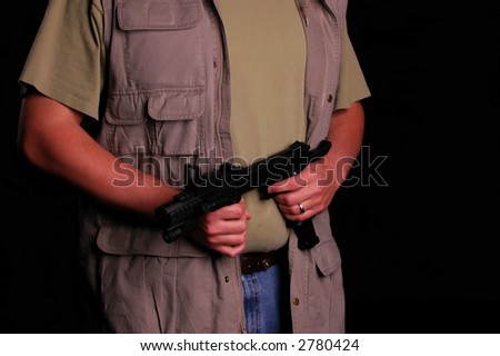 man in hunting vest holding gun