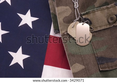 Military Dog Tags on American Flag and fatigues