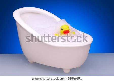 Yellow Rubber Duck in Footed Bathtub with Bubbles
