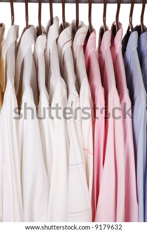 Men's Dress Shirts on Hangers in closet isolated over white
