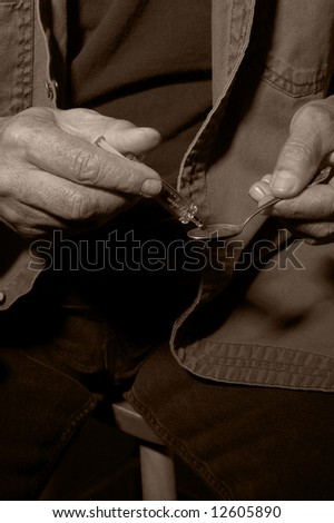 Man With Hypodermic Needle Preparing to Give Himself an Injection