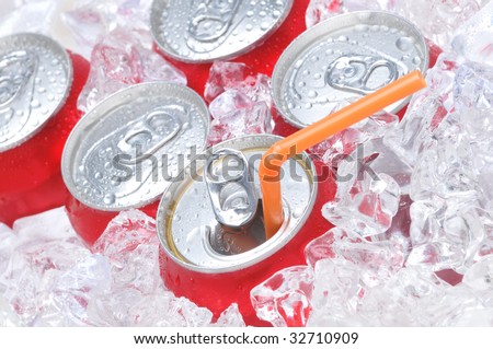Close Up of Soda Cans in Ice with Straw and Condensation