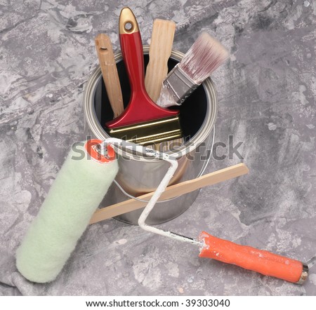 Close up of painting supplies arranged on a drop cloth